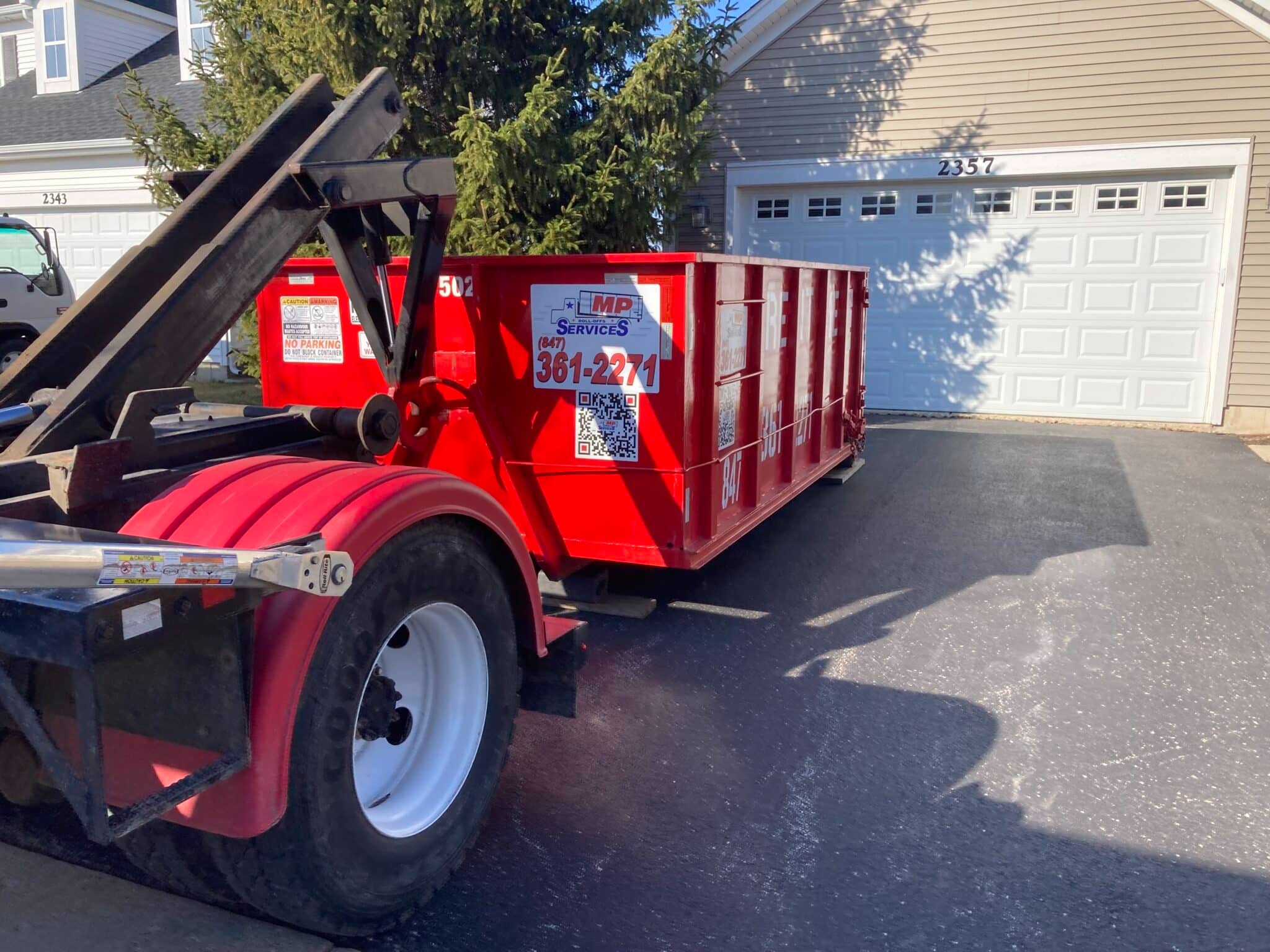 15 yard roll off dumpster delivered on a driveway